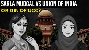 Illustration showing the Supreme Court of India in the background. In the foreground, there are two illustrated women—one wearing a traditional Indian saree and the other wearing a hijab. The text on the image reads: “Sarla Mudgal vs Union of India” and below it: “Origin of UCC?”